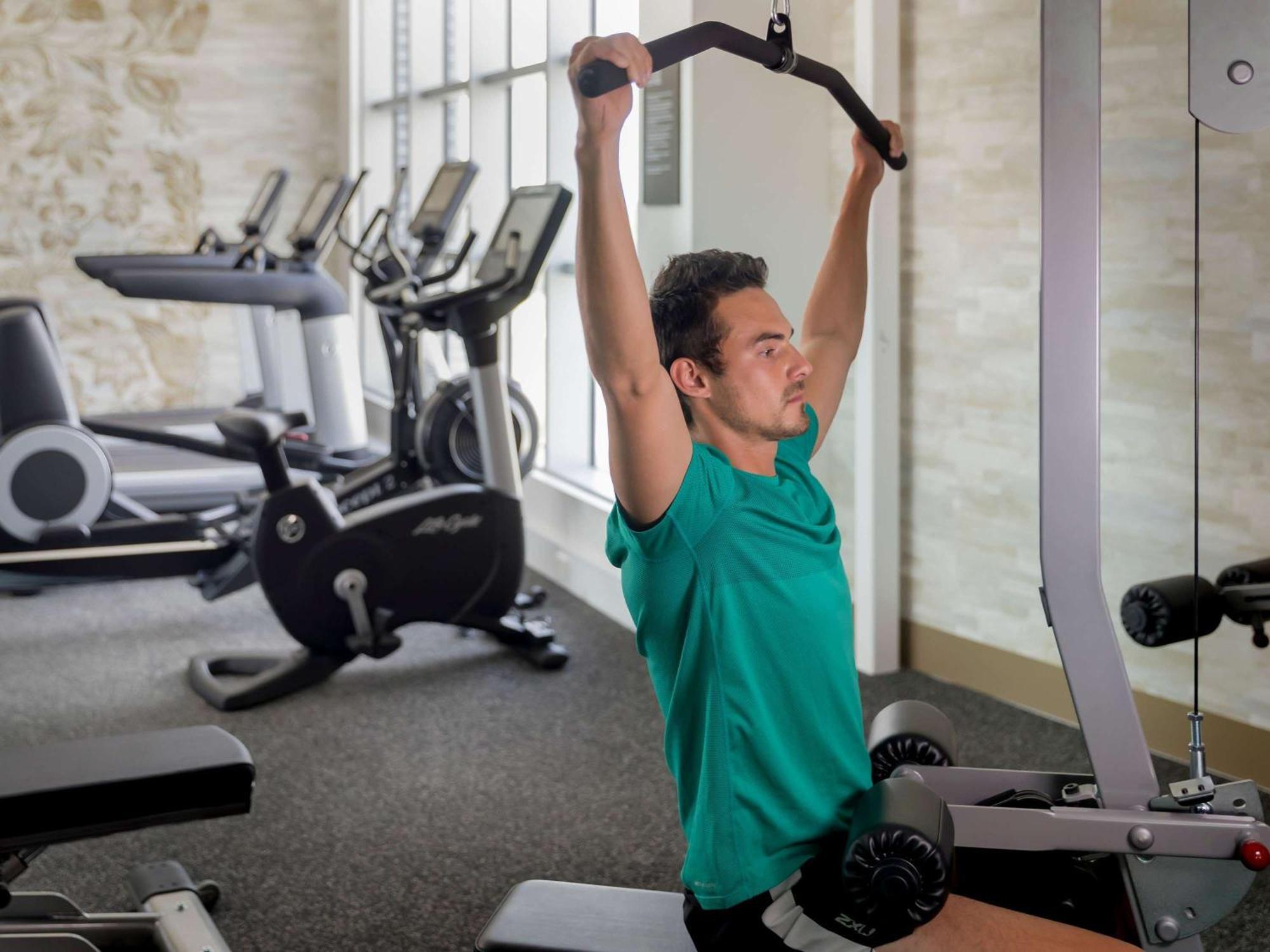 The William Inglis Mgallery Warwick Farm Buitenkant foto A man performing a lat pulldown